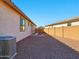 Low-maintenance backyard with a paved patio area and block wall fencing for privacy at 9310 W Atlantis Way, Tolleson, AZ 85353