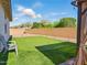 Serene backyard featuring a putting green and comfortable outdoor seating area at 9310 W Atlantis Way, Tolleson, AZ 85353