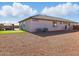 Backyard view shows gravel landscaping, artificial turf putting green, and outdoor gazebo at 9310 W Atlantis Way, Tolleson, AZ 85353