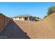 Expansive backyard featuring low maintenance desert landscaping with a covered patio at 9310 W Atlantis Way, Tolleson, AZ 85353