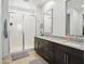 Bathroom features double vanity, framed mirrors, and a tiled walk-in shower at 9310 W Atlantis Way, Tolleson, AZ 85353
