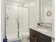 Well lit bathroom features a glass enclosed shower and modern vanity at 9310 W Atlantis Way, Tolleson, AZ 85353
