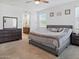 View of primary bedroom shows furnishings and an attached bathroom with double sinks at 9310 W Atlantis Way, Tolleson, AZ 85353
