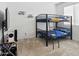 ' bedroom features a space-themed bunk bed, TV, and neutral carpet at 9310 W Atlantis Way, Tolleson, AZ 85353