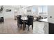 Inviting dining area with tile floors, neutral walls, and views of the cozy living room at 9310 W Atlantis Way, Tolleson, AZ 85353