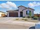 Beautiful single-story home with desert landscaping, tile roof and attached two-car garage at 9310 W Atlantis Way, Tolleson, AZ 85353