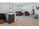 Open floor plan with kitchen island, living room furniture, and tile floors at 9310 W Atlantis Way, Tolleson, AZ 85353