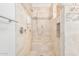 Tiled walk-in shower with a built-in bench and shower niche for storage at 10511 N 87Th Way, Scottsdale, AZ 85258
