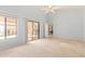 Carpeted primary bedroom with large windows and sliding glass doors to patio at 10511 N 87Th Way, Scottsdale, AZ 85258