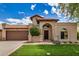 Charming single-story home featuring a Spanish tile roof, arched entryway, and manicured front lawn at 10511 N 87Th Way, Scottsdale, AZ 85258