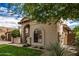 Charming single-story home featuring an arched entryway and manicured front lawn at 10511 N 87Th Way, Scottsdale, AZ 85258