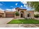 Inviting front exterior with a tile roof, an arched entry, and a well-maintained lawn at 10511 N 87Th Way, Scottsdale, AZ 85258