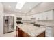 Bright kitchen features granite counters, island, stainless appliances, white cabinets and tiled backsplash at 10511 N 87Th Way, Scottsdale, AZ 85258