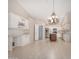 Open kitchen with white cabinetry, stainless steel appliances, center island, and stylish chandelier at 10511 N 87Th Way, Scottsdale, AZ 85258