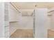A large walk-in closet features ample shelving and hanging space for clothing storage and organization at 10511 N 87Th Way, Scottsdale, AZ 85258