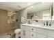 Modern bathroom featuring double sinks, illuminated mirror, and a walk-in shower at 11333 N 92Nd St # 2072, Scottsdale, AZ 85260