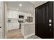 Modern kitchen with white cabinets, stainless steel appliances, and contrasting black door at 11333 N 92Nd St # 2072, Scottsdale, AZ 85260