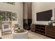 Cozy living room showcasing fireplace, entertainment center and natural light at 11333 N 92Nd St # 2072, Scottsdale, AZ 85260