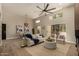 Spacious living area with neutral tones, fireplace, ceiling fan, and lots of seating at 11333 N 92Nd St # 2072, Scottsdale, AZ 85260