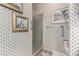 Bathroom featuring neutral patterned walls, a glass enclosed shower, and a toilet at 11360 E Keats Ave # 70, Mesa, AZ 85209