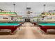 Well-lit billiards room with multiple pool tables, custom lighting, and comfortable seating areas at 11360 E Keats Ave # 70, Mesa, AZ 85209