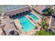Overhead view of a large community pool with lounge chairs, umbrellas, and covered seating areas at 11360 E Keats Ave # 70, Mesa, AZ 85209