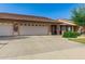 Home exterior featuring a wide driveway and lush, green yard at 11360 E Keats Ave # 70, Mesa, AZ 85209