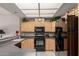 Well-lit kitchen featuring wooden cabinetry, modern black appliances, and a functional layout at 11360 E Keats Ave # 70, Mesa, AZ 85209