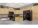 Bright kitchen showcasing wooden cabinets, dark countertops, black appliances, and ample natural light at 11360 E Keats Ave # 70, Mesa, AZ 85209