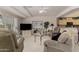 Bright living room featuring cozy seating, soft carpeting, and a view into the kitchen area at 11360 E Keats Ave # 70, Mesa, AZ 85209