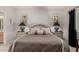 Well-appointed main bedroom featuring a plush bed, decorative lamps, and elegant wall art at 11360 E Keats Ave # 70, Mesa, AZ 85209