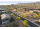 Scenic aerial view of a Primary-planned community surrounded by mountains and desert landscape at sunset at 12269 E Chiricahua Pl, Gold Canyon, AZ 85118