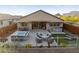 This home's backyard boasts a built-in outdoor kitchen, hot tub, pergola, and artificial turf at 12269 E Chiricahua Pl, Gold Canyon, AZ 85118