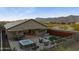A fenced backyard featuring a hot tub, lounge chairs, a built-in grill, and an outdoor dining area at 12269 E Chiricahua Pl, Gold Canyon, AZ 85118