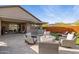 Backyard sitting area with comfortable chairs surrounding a gas firepit, perfect for outdoor gatherings at 12269 E Chiricahua Pl, Gold Canyon, AZ 85118