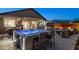 Inviting backyard with a modern hot tub, outdoor kitchen, and seating area perfect for entertaining at 12269 E Chiricahua Pl, Gold Canyon, AZ 85118