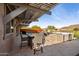 Covered patio with a hot tub, dining table and chairs overlooking backyard landscaping at 12269 E Chiricahua Pl, Gold Canyon, AZ 85118