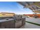 Backyard featuring an outdoor kitchen with a stainless steel grill, dining and a raised spa at 12269 E Chiricahua Pl, Gold Canyon, AZ 85118
