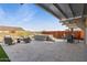 Backyard oasis with travertine pavers, a hot tub, an outdoor dining area, and lounge seating at 12269 E Chiricahua Pl, Gold Canyon, AZ 85118