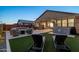 Inviting backyard showcases a hot tub, outdoor kitchen, lounge chairs, and a cozy seating area with a fire pit at 12269 E Chiricahua Pl, Gold Canyon, AZ 85118