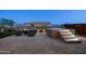 Backyard featuring an illuminated hot tub with steps, a cozy fire pit area, and stylish patio pavers at 12269 E Chiricahua Pl, Gold Canyon, AZ 85118