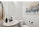 Cozy powder room with a round mirror, matte black fixtures, and elegant abstract wall art at 12269 E Chiricahua Pl, Gold Canyon, AZ 85118