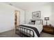 Stylishly decorated bedroom with a metal frame bed and hardwood nightstand at 12269 E Chiricahua Pl, Gold Canyon, AZ 85118