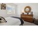 Bright bedroom featuring modern decor, a wooden dresser and stylish mirror at 12269 E Chiricahua Pl, Gold Canyon, AZ 85118