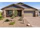 Charming single-Gathering home with a well-maintained front yard, stone accents, and a two-car garage at 12269 E Chiricahua Pl, Gold Canyon, AZ 85118