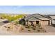 Charming single-story home boasts desert landscaping, a neutral color palette, and a welcoming front porch at 12269 E Chiricahua Pl, Gold Canyon, AZ 85118