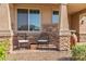 Cozy front porch featuring comfortable seating, stone accents, and decorative planter at 12269 E Chiricahua Pl, Gold Canyon, AZ 85118