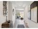 Bright and spacious hallway with wood-look flooring and modern decor leading to the backyard at 12269 E Chiricahua Pl, Gold Canyon, AZ 85118