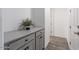 Stylish hallway features built in storage and grey cabinets with matte black hardware and wood-look floors at 12269 E Chiricahua Pl, Gold Canyon, AZ 85118