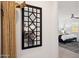 Hallway view with decorative mirror leading to a bedroom featuring a bed with a ceiling fan at 12269 E Chiricahua Pl, Gold Canyon, AZ 85118